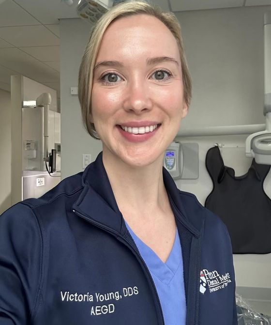 Victoria Young, DDS, in scrubs in a dental clinic